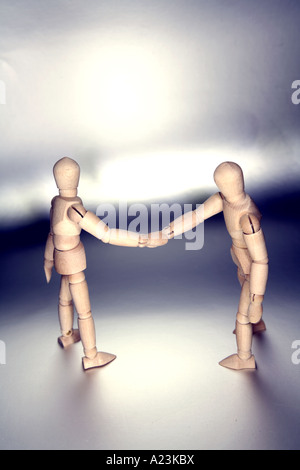 Wooden figures shaking hands Stock Photo