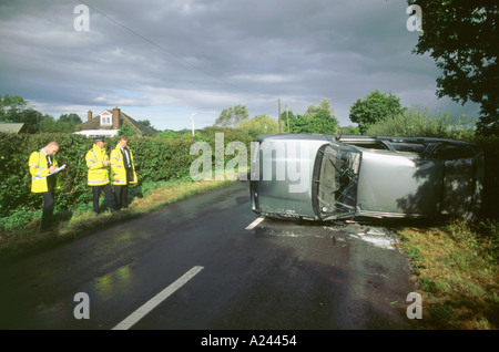 Road accident with Ford Sierra on its side 2000 Stock Photo