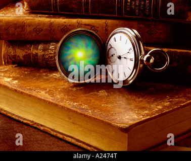A mystical old pocket watch sitting on some antique books Stock Photo