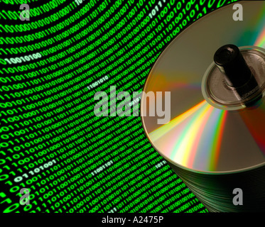 Close up of a stack of CD DVD disks on a Dutch angle with a curved field of binary code Stock Photo