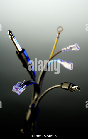 Computer USM Audio and Electronic Cables bunched together with blue keylight and graduated background Stock Photo