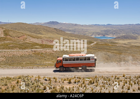 An overland adventure holiday truck driving on a dirt road through the rugged landscape scenery of Peru. Stock Photo