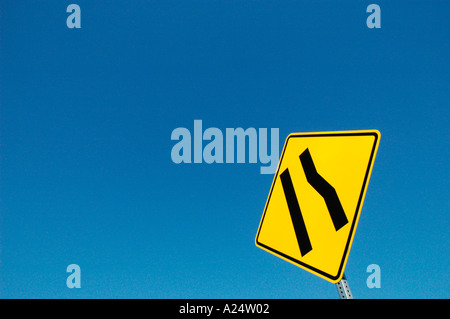 Freeway sign showing merge left as lane ends Stock Photo