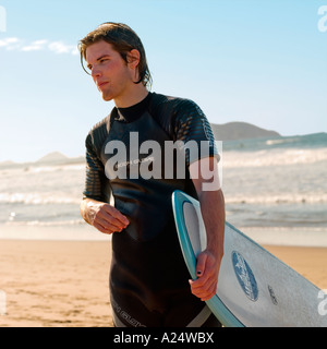 A surfer with his board on Playa Bruja beach Mazatlan Sinaloa Mexico Stock Photo