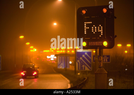 Fog warning sign on the M1 motorway, Leicestershire, UK, during foggy weather Stock Photo