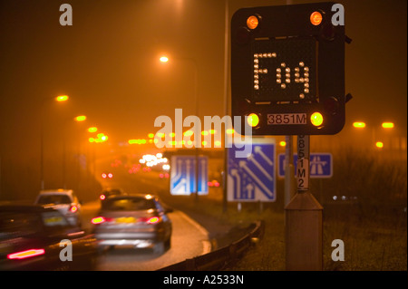 Fog warning sign on the M1 motorway, Leicestershire, UK, during foggy weather Stock Photo