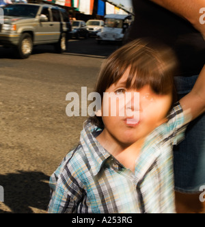 Boy with parent cross a street in Mazatlan Mexico Stock Photo