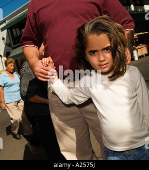 Girl holds her father's hand on the streets of downtown Mazatlan Mexico Stock Photo