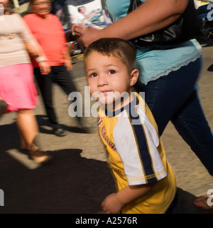 Boy holds his mother's hand on the streets of downtown Mazatlan Mexico Stock Photo