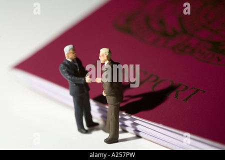 Two businessman shake hands in front of a paasport Stock Photo