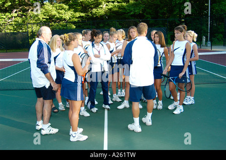 Tennis coach discusses strategy with female tennis team Stock Photo