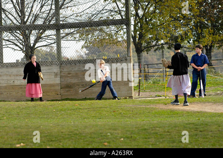 Children play baseball softball in schoolyard Amish lifestyle in and around Sugarcreek and Millersburg Ohio OH Stock Photo