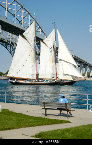 The Tall Ship Highlander sails under the Blue Water International Bridge at Port Huron Michigan MI Stock Photo