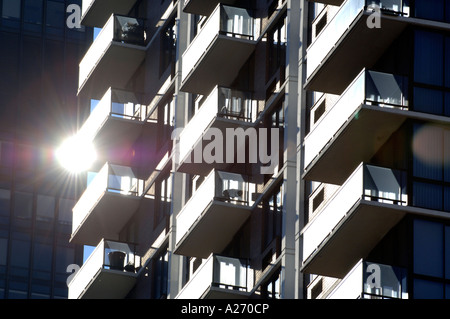The sun reflects off the balconies of a skyscraper on the East side of central Manhattan New York USA Stock Photo