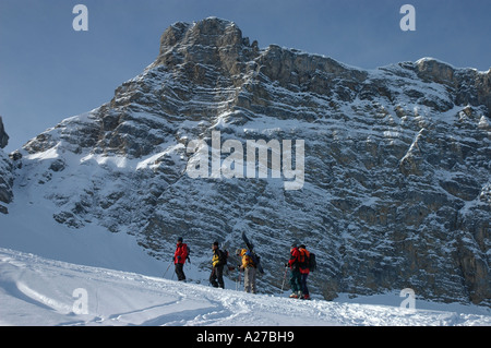 Ski and snowboard mountaineers ascending Rauflihorn in witner Diemtigtal Bernese Alps Switzerland Stock Photo