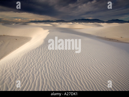 Beautiful wind sculpted white gypsum dunes in the White Sands National Monument Early morning Stock Photo