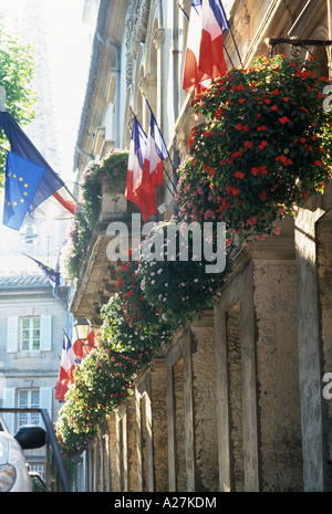 Provencal townhouse with hanging flower baskets and french flags Stock Photo