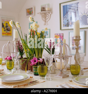 Set table decorated with daffodils and candles in London townhouse Stock Photo