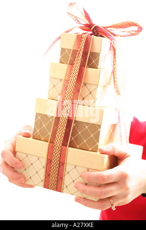 Hands holding stack of gifts with ribbon.  Selective soft focus effect. Stock Photo