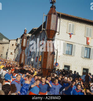 Corsa dei Ceri festival Gubbio, Umbria, Italy. Teams carry traditional ceri with icons of patron saints in a race through town. Stock Photo