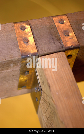 BUILDING AN EXTENSION TWO JOISTS SECURED WITH A STEEL JOIST HANGER Stock Photo