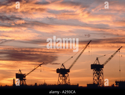 Cranes on docks at sunset in Boston Inner harbor Boston Massachusetts Stock Photo