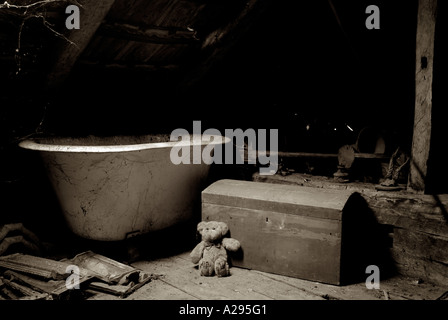 Childs Teddy Bear and an Old Toy Chest in the Dusty Attic Space of a House Stock Photo