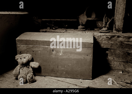 Teddy Bear and an Old Toy Chest in the Dusty Attic Space of a House Stock Photo