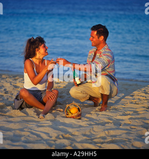 YOUNG COUPLE DRINKING WINE ON A CYPRIOT BEACH IN EARLY EVENING Stock Photo