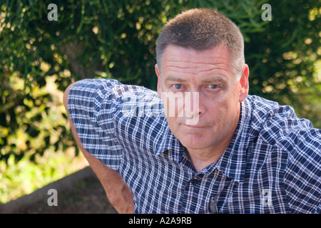 Portrait of a handsome middle aged man in an outdoor setting. Stock Photo