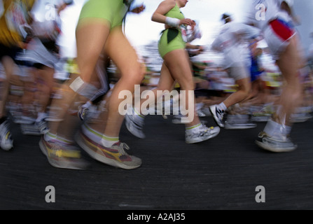 The blur of a crowd of runner s legs distorted by a wide angled lens during the London Marathon Stock Photo