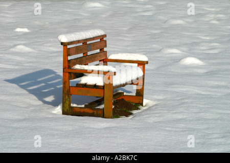 wooden bench in the park is covered with snow Stock Photo - Alamy
