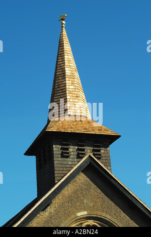 Tower of parish church reclad in new timber cedar shingles before weathering to grey colour Stock Photo