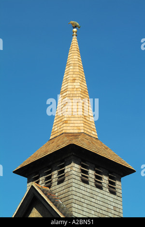 Tower of parish church reclad in new timber cedar shingles before weathering to grey colour Stock Photo