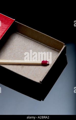 Single wooden match in matchbox Stock Photo