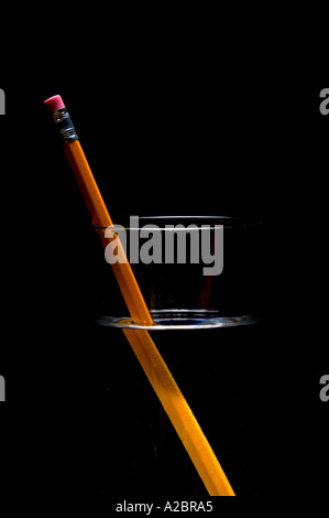 Pencil in glass of water showing light refraction Stock Photo