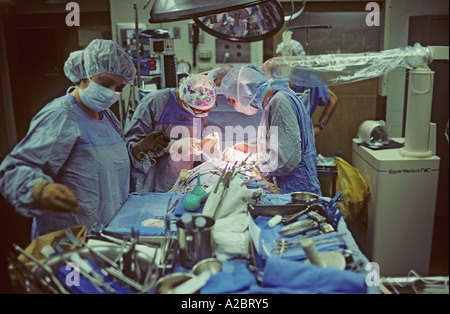 doctors and nurses performing surgery in hospital operating room Stock Photo