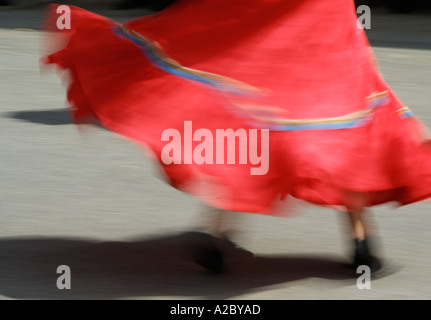 Swirling red skirt of a french country dancer at a folk festival in Lacock Wiltshire England UK GB EU Europe Stock Photo