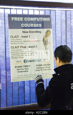 a woman looking through LearnDirect office window for computer training courses in town of Stowmarket Suffolk UK December 2006 Stock Photo