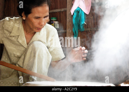 Woman making rice cakes Mekong Delta Vietnam Stock Photo