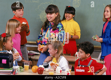 Group of children of all ethnic groups having school lunch together Stock Photo