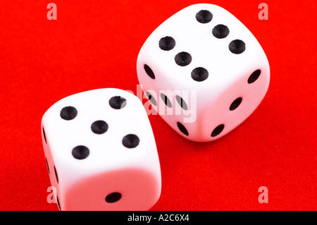 A pair of dice rolled on a red baize cloth Stock Photo