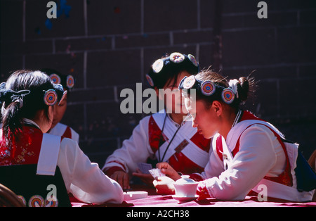 local Naxi Chinese women playing cards Lijiang Yunnan Province China Stock Photo