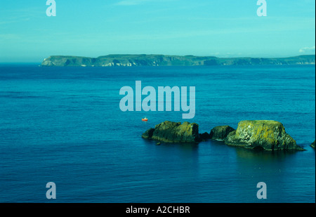 lonely fishing boat in the Atlantic Ocean off the Causeway Coast in County Antrim in Northern Ireland Stock Photo