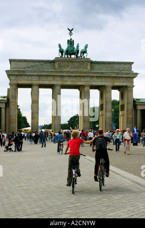 A couple of cyclists enjoy the view of the Brandenberg Gate, Berlin, Germany Stock Photo