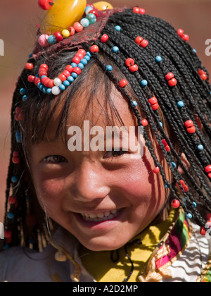 Tibetan girl with braids smiling Stock Photo