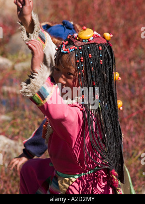 Tibetan girl with braids dancing Stock Photo