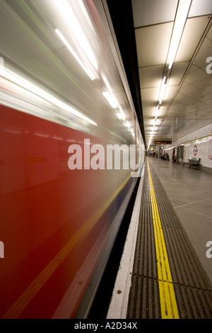 London Underground tube network with speeding train entering station ...