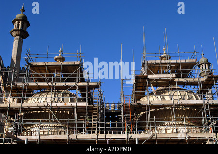 The domes of the Prince Regents Palace The Royal Pavilion Brighton East Sussex are covered in scaffolding for stonework repairs Stock Photo