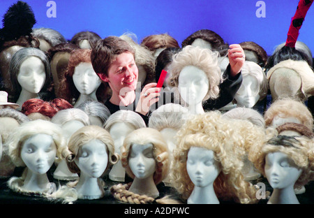 An opera company wig mistress titivates one of the many wigs used in every performance. Stock Photo